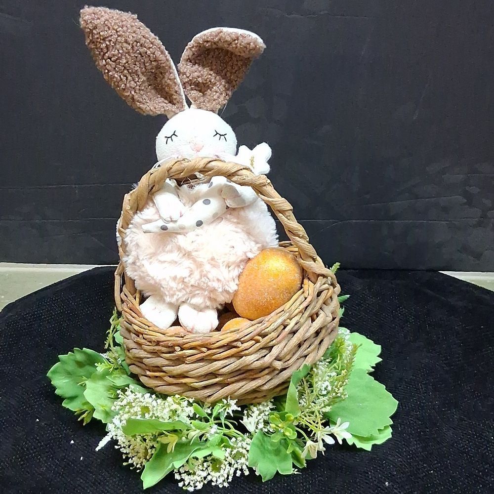 Fuzzy bunny In Basket of Golden Eggs Nestled In White floral Ring‎ Of Flowers.